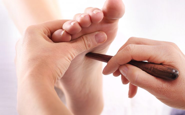 Natural medicine, reflexology, acupressure foot massager oppresses energy flow points
** Note: Shallow depth of field